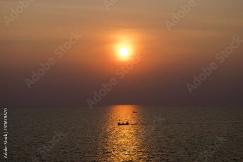 the sun falls Thai sea and fishing tiny boat , © Teera