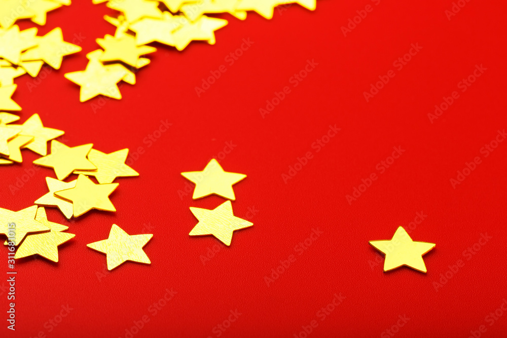 A scattering of Gold stars on a red background. Greeting cards, headlines and website concept. A scattering of Gold stars on a red background. Greeting cards, headlines and website concept.