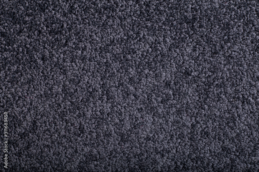 Fototapeta premium Carpet covering background. Pattern and texture of black colour carpet. Copy space.