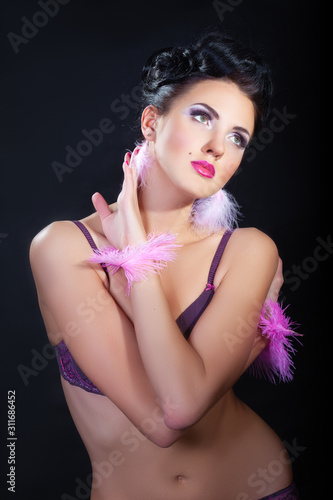 attractive female model in lingerie posing on dark studio background 