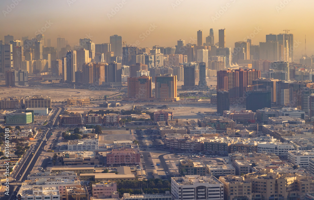 Aerial shot of buildings in Dubai city at sunrise