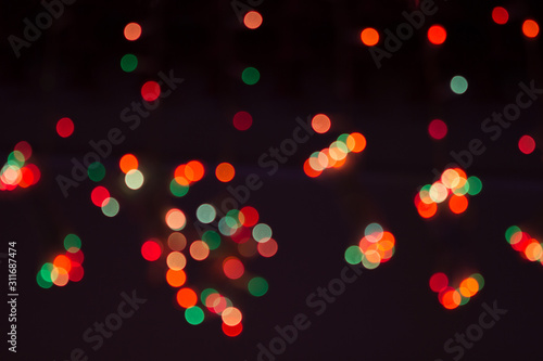 orange, green, red, yellow and gold bokeh on a black background