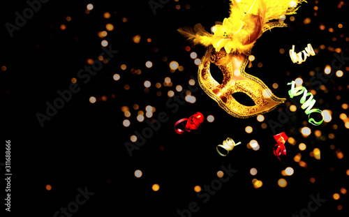 Masquerade mask on black background with sparkles. The concept of traditional holidays. Close-up
