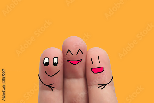 three best friends hands fingers of man and woman on yellow background