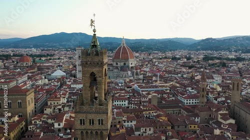 Drone rotating shot around bell tower in Florence with Cathedral of Santa Maria del Fiore in bakground, Italy photo