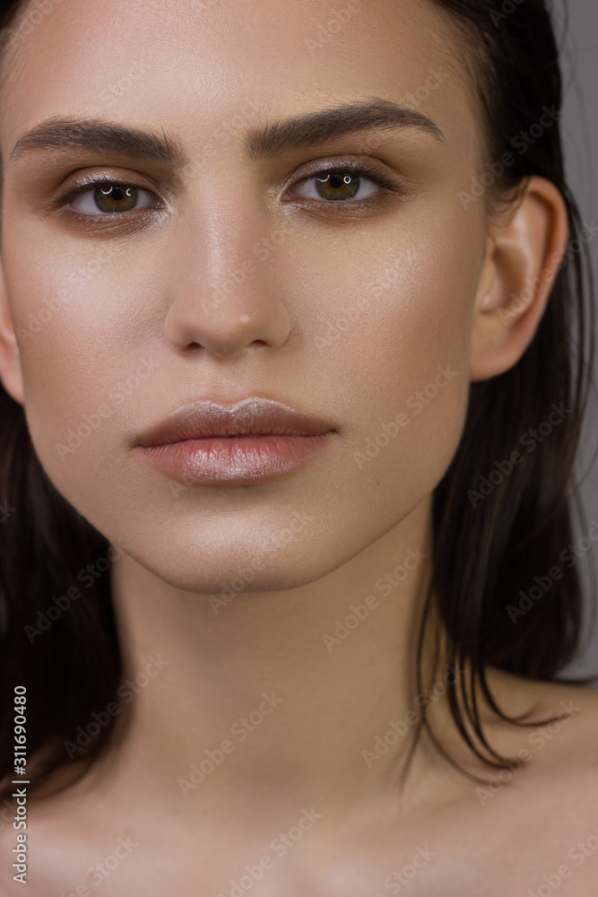Close-up portrait of the cleanliness face of a beautiful woman with dark black smoky eyes makeup, natural full lips. Sexy model with clean shiny skin, clean face, long curly hair. glamorous image Close-up portrait of the cleanliness face of a beautiful woman with dark black smoky eyes makeup, natural full lips. Sexy model with clean shiny skin, clean face, long curly hair. glamorous image