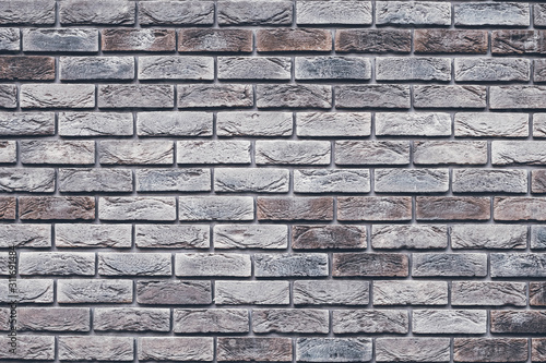 Brown brick wall texture. Gray grunge brickwork. Decorative tile surface. Bricks backgrounds. Messy wall pattern for wallpaper design. Concrete stone background.