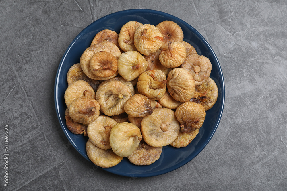 Tasty dried figs on grey table, top view Tasty dried figs on grey table, top view