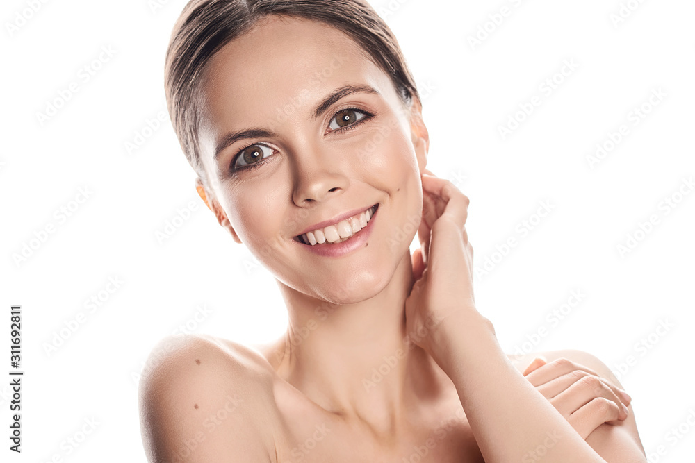 Portrait of beautiful young brunette woman with clean face. High key shot.