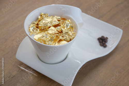 24 carat gold coffee. A cup of coffee sprinkled with 24 carat gold flakes