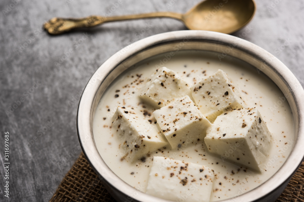 Paneer Dum Kali Mirch / Kalimirch, prepared in a white creamy gravy and black pepper powder sprinkled over it. served in a bowl. Selective focus Paneer Dum Kali Mirch / Kalimirch, prepared in a white creamy gravy and black pepper powder sprinkled over it. served in a bowl. Selective focus
