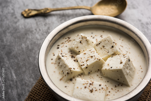 Paneer Dum Kali Mirch / Kalimirch, prepared in a white creamy gravy and black pepper powder sprinkled over it. served in a bowl. Selective focus photo