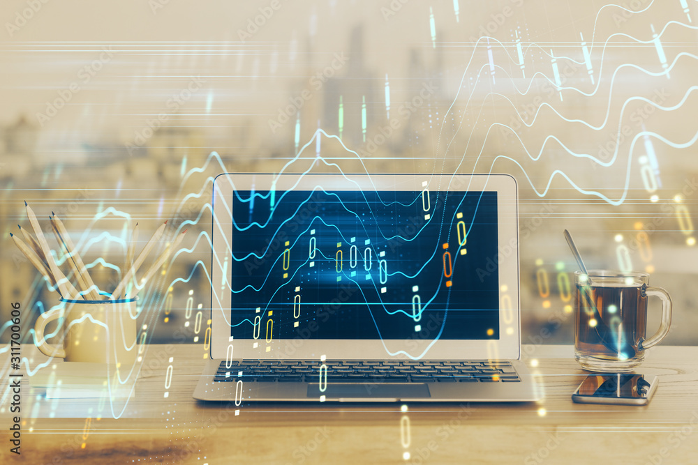 Stock market chart hologram drawn on personal computer background. Double exposure. Concept of investment. Stock market chart hologram drawn on personal computer background. Double exposure. Concept of investment.