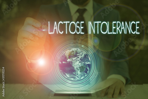 Conceptual hand writing showing Lactose Intolerance. Concept meaning digestive problem where body is unable to digest lactose Elements of this image furnished by NASA photo