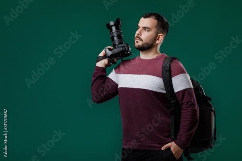 bearded man photographer takes images with professional digital photo camera. copy space