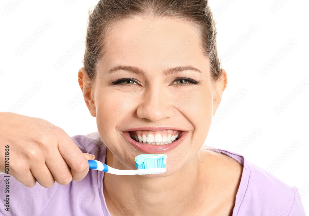 Young woman brushing teeth on white background Young woman brushing teeth on white background