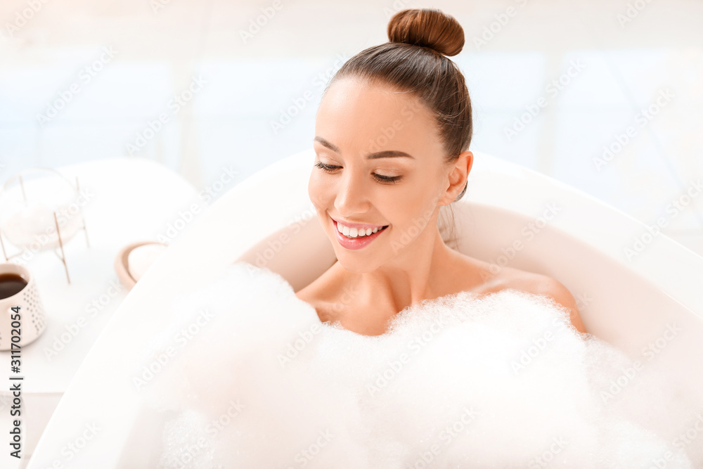 Beautiful young woman relaxing in bathtub Beautiful young woman relaxing in bathtub
