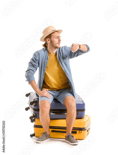 Young tourist with luggage ...