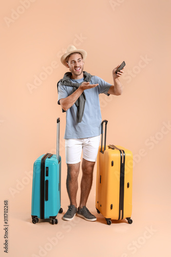 Young tourist with luggage ...