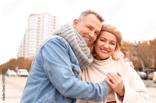 Portrait of happy mature couple outdoors on autumn day