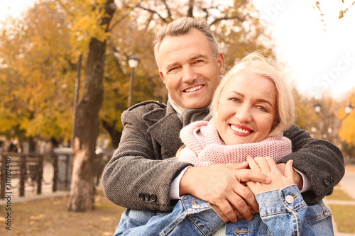 Happy mature couple in autu...