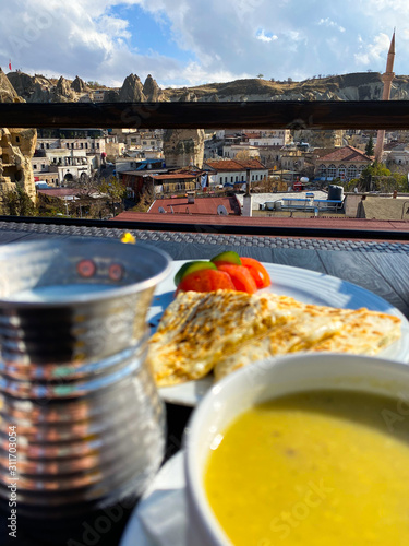 Soup mashed, pita, tomatoes stand on a table against the background of a blurred city landscape. Turkey. Dinner. Tourism.