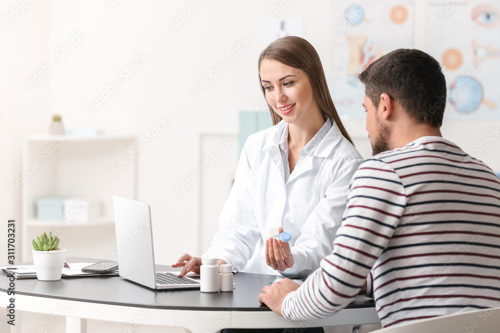 Ophthalmologist explaining patient how to use contact lenses Ophthalmologist explaining patient how to use contact lenses