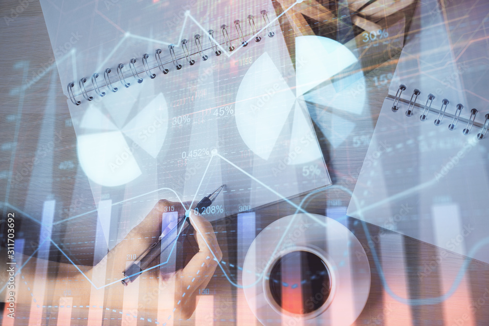 Multi exposure of woman's hands making notes with forex graph hologram. Concept of technical analysis. Multi exposure of woman's hands making notes with forex graph hologram. Concept of technical analysis.