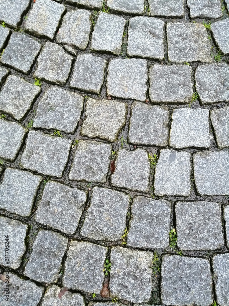 Old road paved with granite stones texture background Old road paved with granite stones texture background
