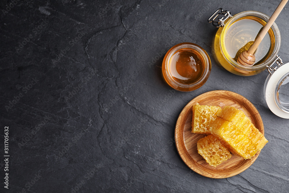 Flat lay composition with delicious honey on black table. Space for text Flat lay composition with delicious honey on black table. Space for text