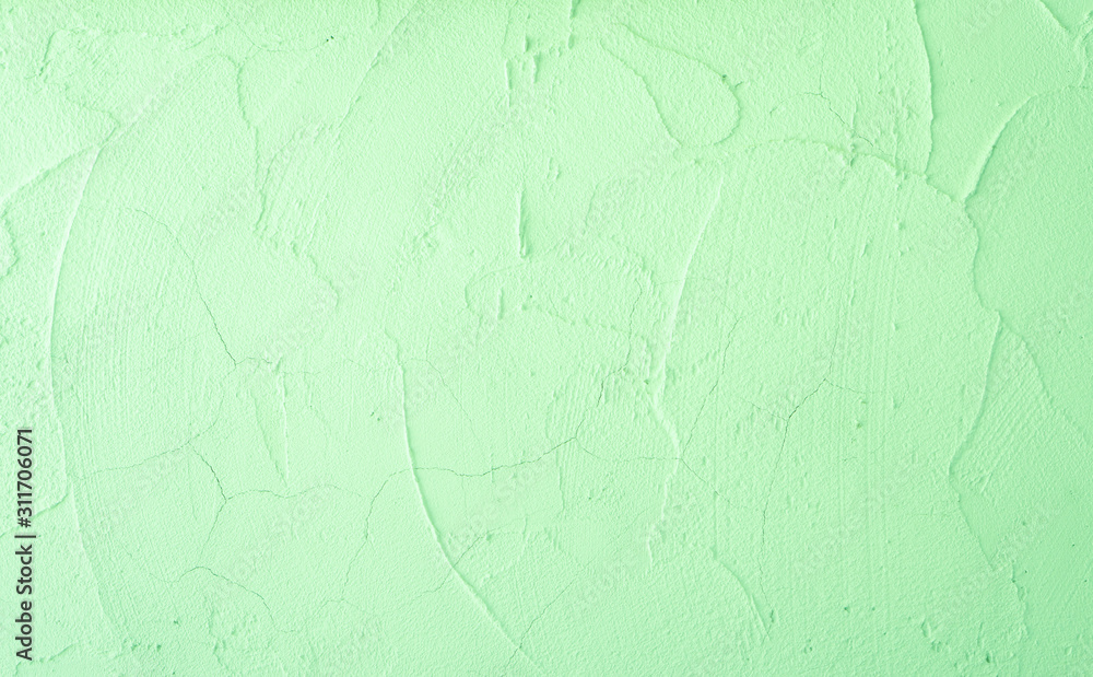 Fototapeta premium Green pastel color of rough surface mortar concrete wall with random texture cement plaster masory man's work
