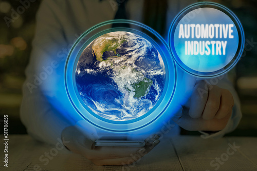 Writing note showing Automotive Industry. Business concept for organizations involved in the business of motor vehicles Elements of this image furnished by NASA