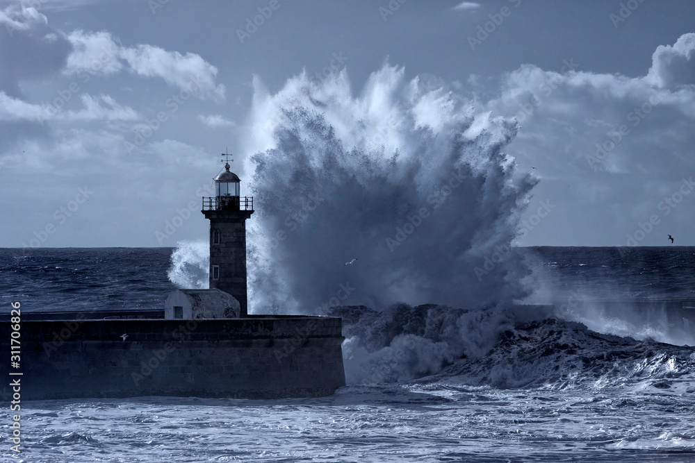 Stormy waves splash over lighthouse