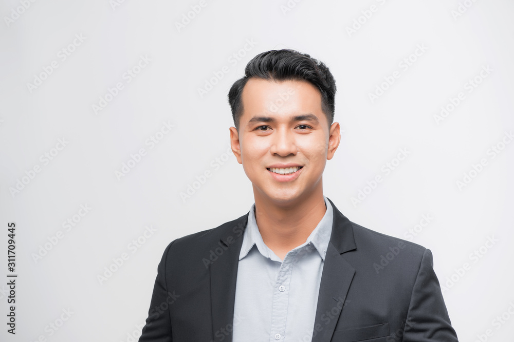 Confident Asian businessman smiling and looking at the camera Confident Asian businessman smiling and looking at the camera