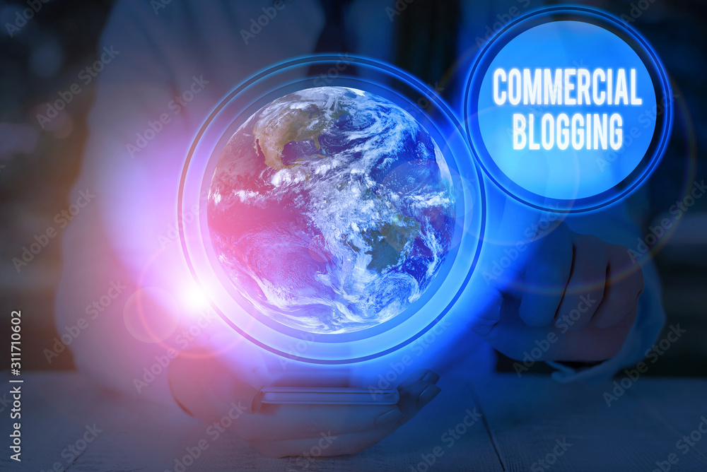 Writing note showing Commercial Blogging. Business concept for published and used by an organization or corporation Elements of this image furnished by NASA Writing note showing Commercial Blogging. Business concept for published and used by an organization or corporation Elements of this image furnished by NASA
