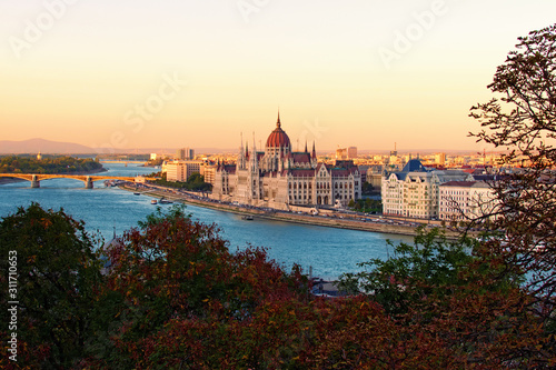 Aerial landscape view of Budapest. Picturesque Danube River and The Hungarian Parliament Building during sunset. Autumn colors in the background. Budapest, Hungary © evgenij84