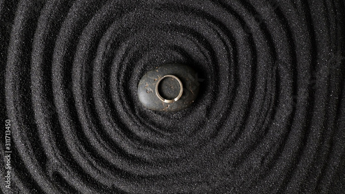 Photography Ring on dark stone with circle dark sand background