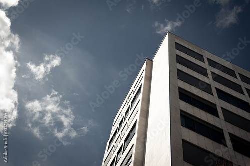 Generic high rise building towards blue sky with clouds
