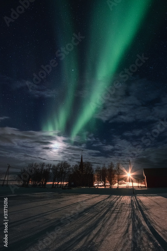 Northern lights, Aurora Borealis with starry in the night sky over Flakstad church in Lofoten Islands