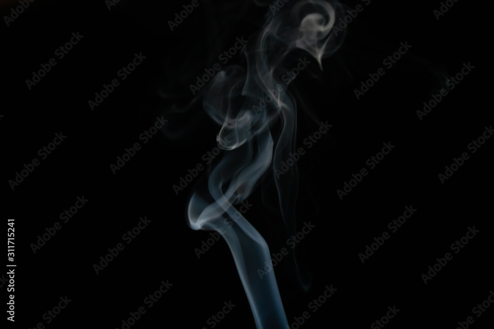 Abstract smoke background with copy space on black background. Blue-white smoke rose from the incense stick. Figures of smoke Abstract smoke background with copy space on black background. Blue-white smoke rose from the incense stick. Figures of smoke