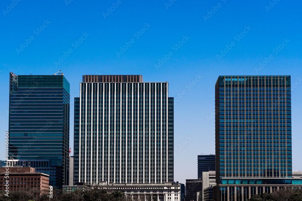 Tokyo city buildings against blue sky