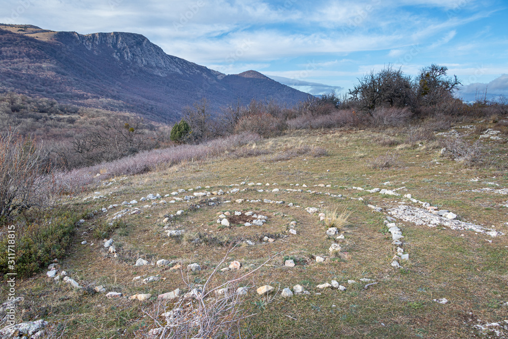 Esoteric place of power - spiral laid out of stones on the top of Paragilmen Mountain. Lifestyle. Esoteric place of power - spiral laid out of stones on the top of Paragilmen Mountain. Lifestyle.