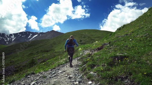 Ultra trail running, sport activities, mountain trails marathon. Trail runner climbing a stone trail to the mountain top.
