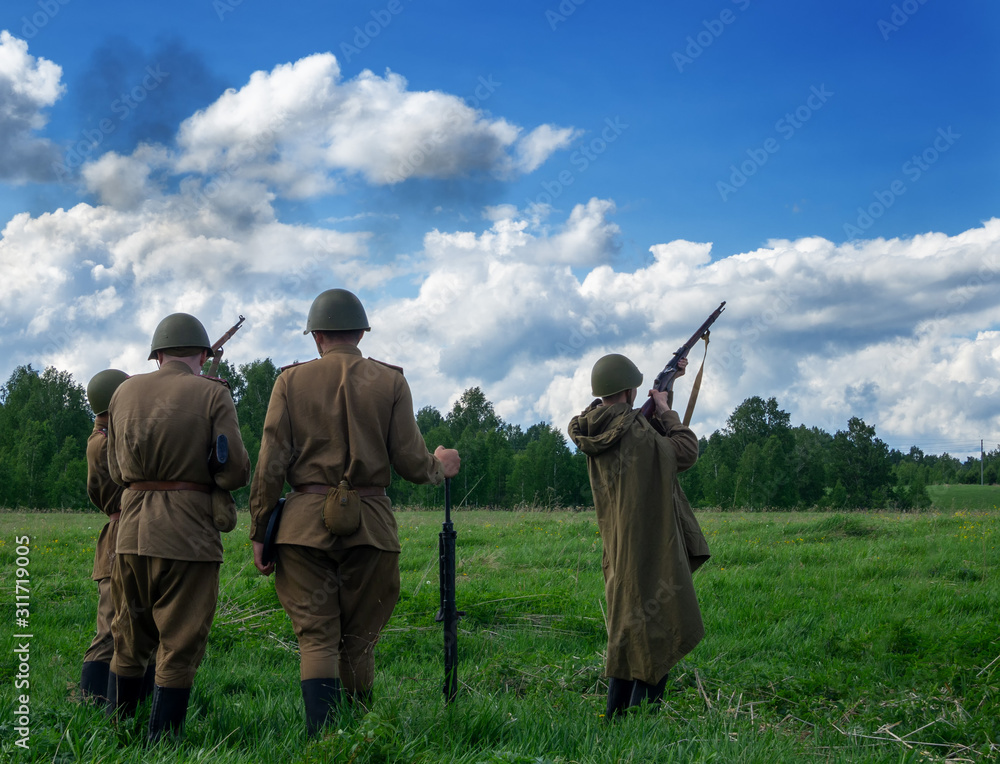 Obraz premium Soldiers in uniform and helmets during the Great Patriotic War with rifles at the shooting range.