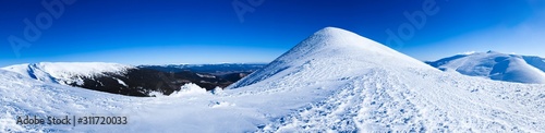 Panoramic view of mountains covered with snow © YouraPechkin