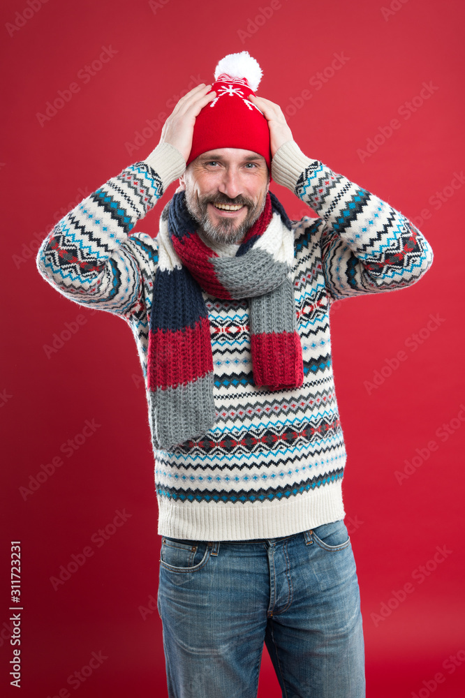 Knitwear accessories. Winter trends. Knitted hat scarf and sweater. Winter knitwear. Mature man red background. Cold weather concept. Bearded man in winter style. Caucasian man wear warm clothes Knitwear accessories. Winter trends. Knitted hat scarf and sweater. Winter knitwear. Mature man red background. Cold weather concept. Bearded man in winter style. Caucasian man wear warm clothes