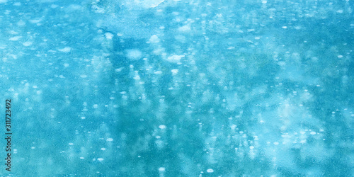 Air bubbles in ice. Winter freeze icy, panoramic view. Frozen bubbles in ice, blue winter algid background, glacial