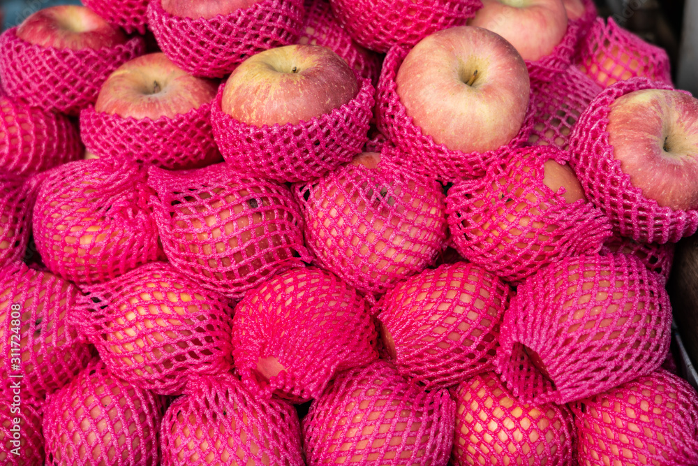 A apple pile with pink foam nets for sale A apple pile with pink foam nets for sale