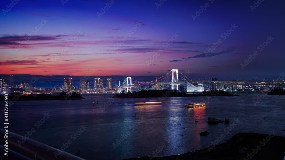 rainbow bridge of odaiba tokyo japan with cityscape in sunset skyline