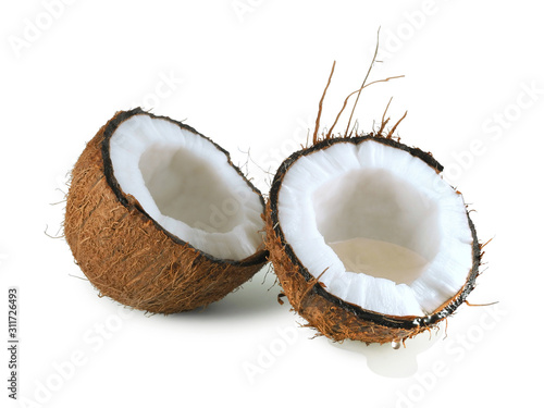 Halved coconut with flowing drops of coconut water isolated on a white background 